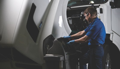 heavy duty truck technician examining a truck