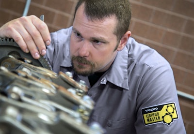 Volvo Certified Master Technician inspecting truck components