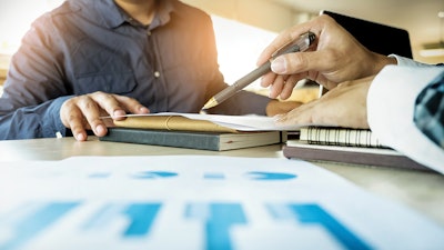 Two people going over paperwork