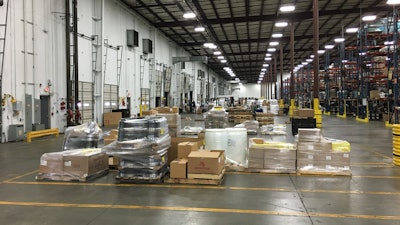 large warehouse with sections of boxes and other products