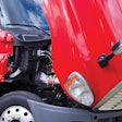 red semi truck with hood lifted