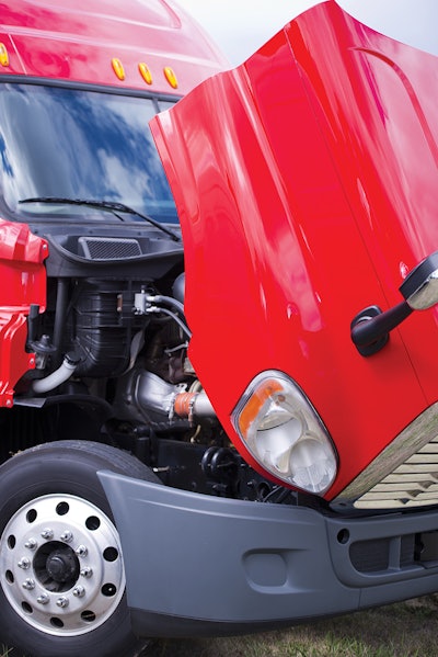 red semi truck with hood lifted