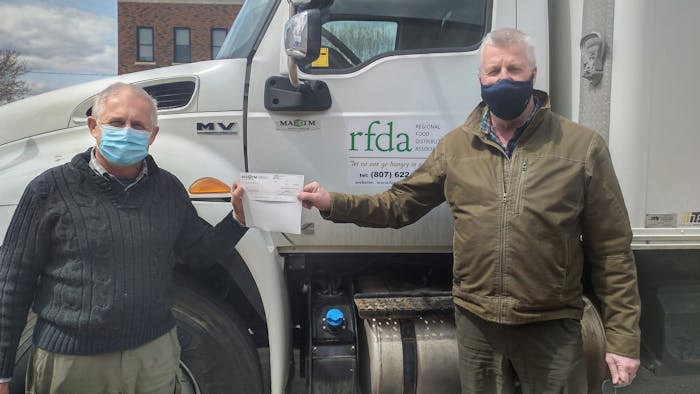 Volker Kromm, executive director of the Regional Food Distribution Association (on left) accepts a $5,000 donation cheque from Darrin Poulin, general manager of Maxim Truck & Trailer’s Thunder Bay branch office.