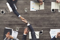 Shutterstock Shaking Hands At Table