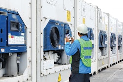 Worker using app on cooling systems