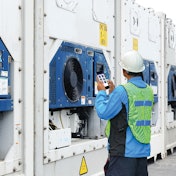 Worker using app on cooling systems