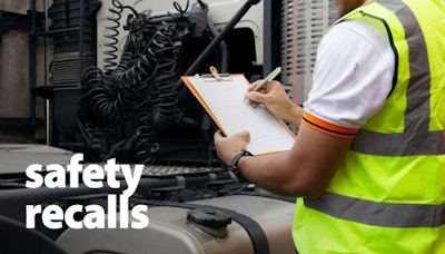 Worker inspecting a heavy-duty truck.