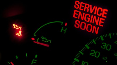 Truck dashboard with Service Engine Soon light.