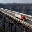 Truck driving across bridge