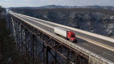 Truck driving across bridge
