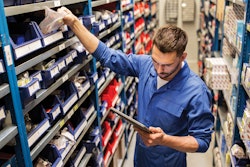 Employee pulling truck parts.