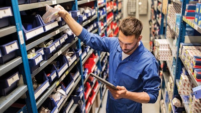 Employee pulling truck parts.