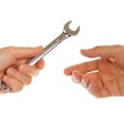 Handing off wrench to technician.