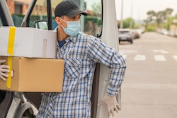 Masked up man delivering parts.