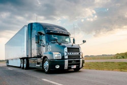 Mack Anthem truck driving down the road.