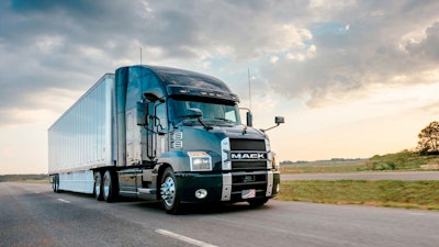 Mack Anthem truck driving down the road.