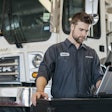 Mack technician running diagnostics on a truck