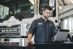 Mack technician running diagnostics on a truck