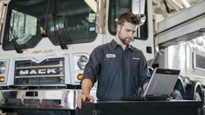 Mack technician running diagnostics on a truck