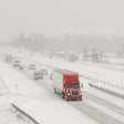 Truck driving on snowy expressway