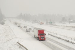 Truck driving on snowy expressway
