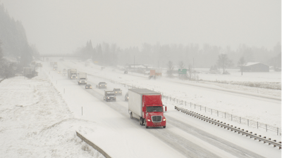 Truck driving on snowy expressway