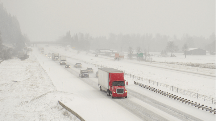 Truck driving on snowy expressway