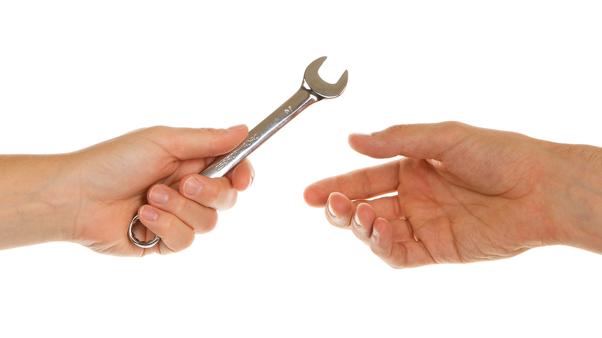 Wrench being handed to technician.