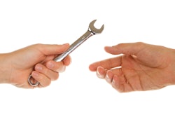 Wrench being handed to technician.
