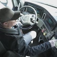 Technician checking truck data on dashboard.