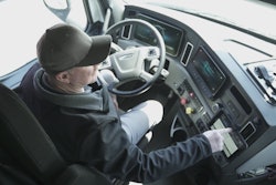 Technician checking truck data on dashboard.