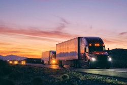 Trucks driving on the expressway (dusk or dawn).