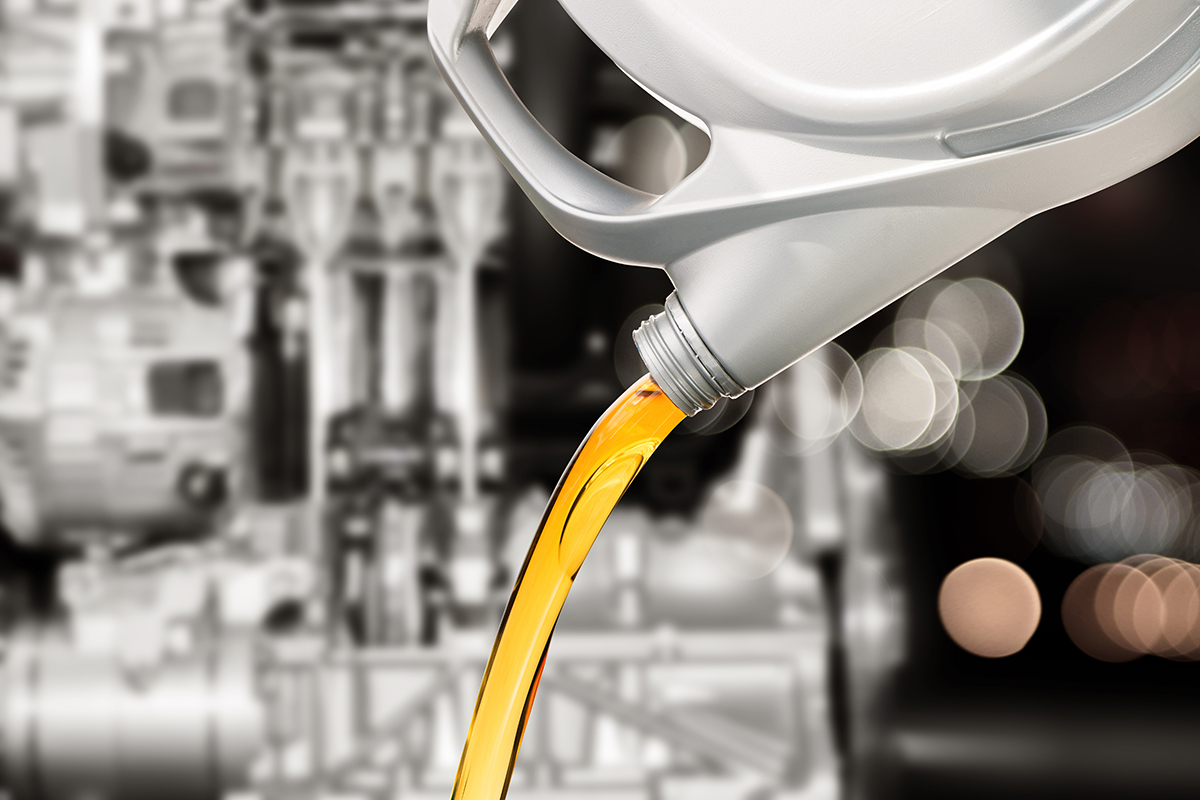 Pouring motor oil from bottle.