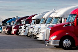 Used trucks parked in a lot.