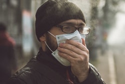 Man wearing mask, protecting himself from Omicron variant.