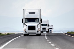 Trucks on highway coming at photo