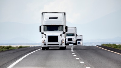 Trucks on highway coming at photo