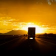 Truck driving into sun