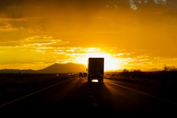 Truck driving into sun