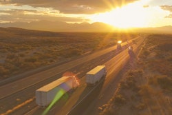 Trucks driving down highway
