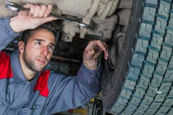 Technician working under truck