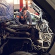 Truck technician working on truck engine