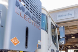 Mack LR Electric in front of a Ballard Truck Center EV service bay