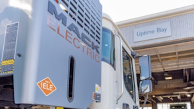 Mack LR Electric in front of a Ballard Truck Center EV service bay