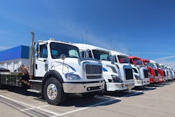 A line of multiple OEM used trucks parts on a lot