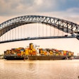 Container ship passing under Bayonne Bridge in New Jersey