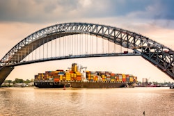 Container ship passing under Bayonne Bridge in New Jersey