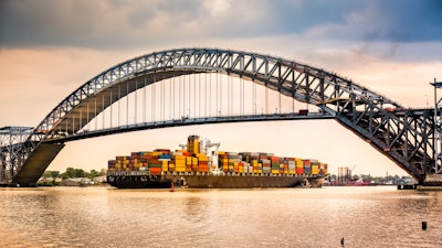 Container ship passing under Bayonne Bridge in New Jersey