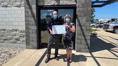 Helen Devos check presentation by West Michigan International
