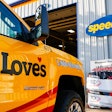 Love's service truck parked in front of a Speedco facility